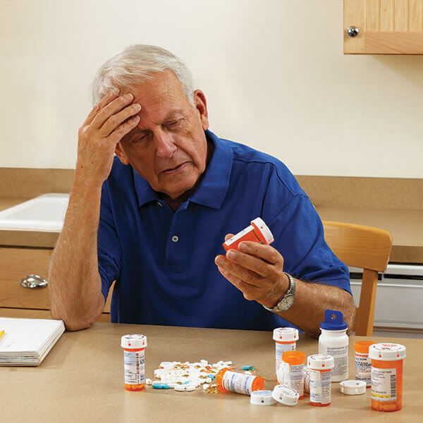 Senior looking at his medications