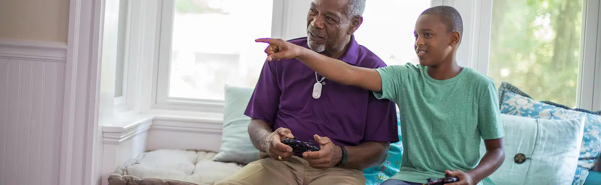 Senior playing video game with his grandchild