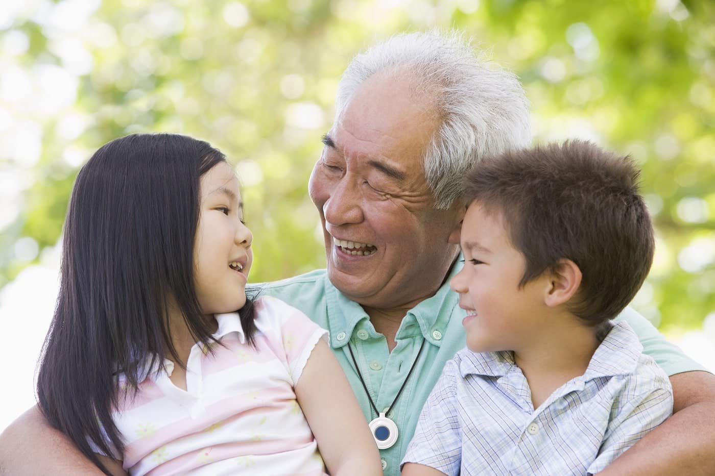 Grandpa holding his nephew an niece