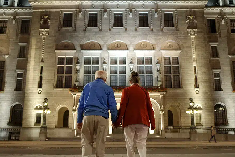 Senior couple going to the museum in the evening