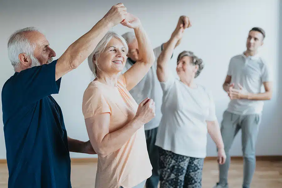 Seniors dancing with their partners during dancing class