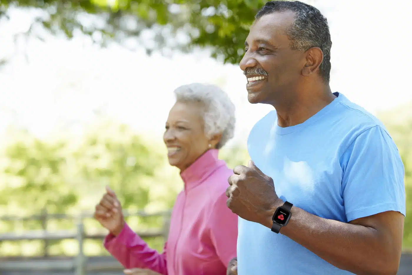 Two seniors running outside