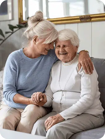 Two seniors sitting on the couch
