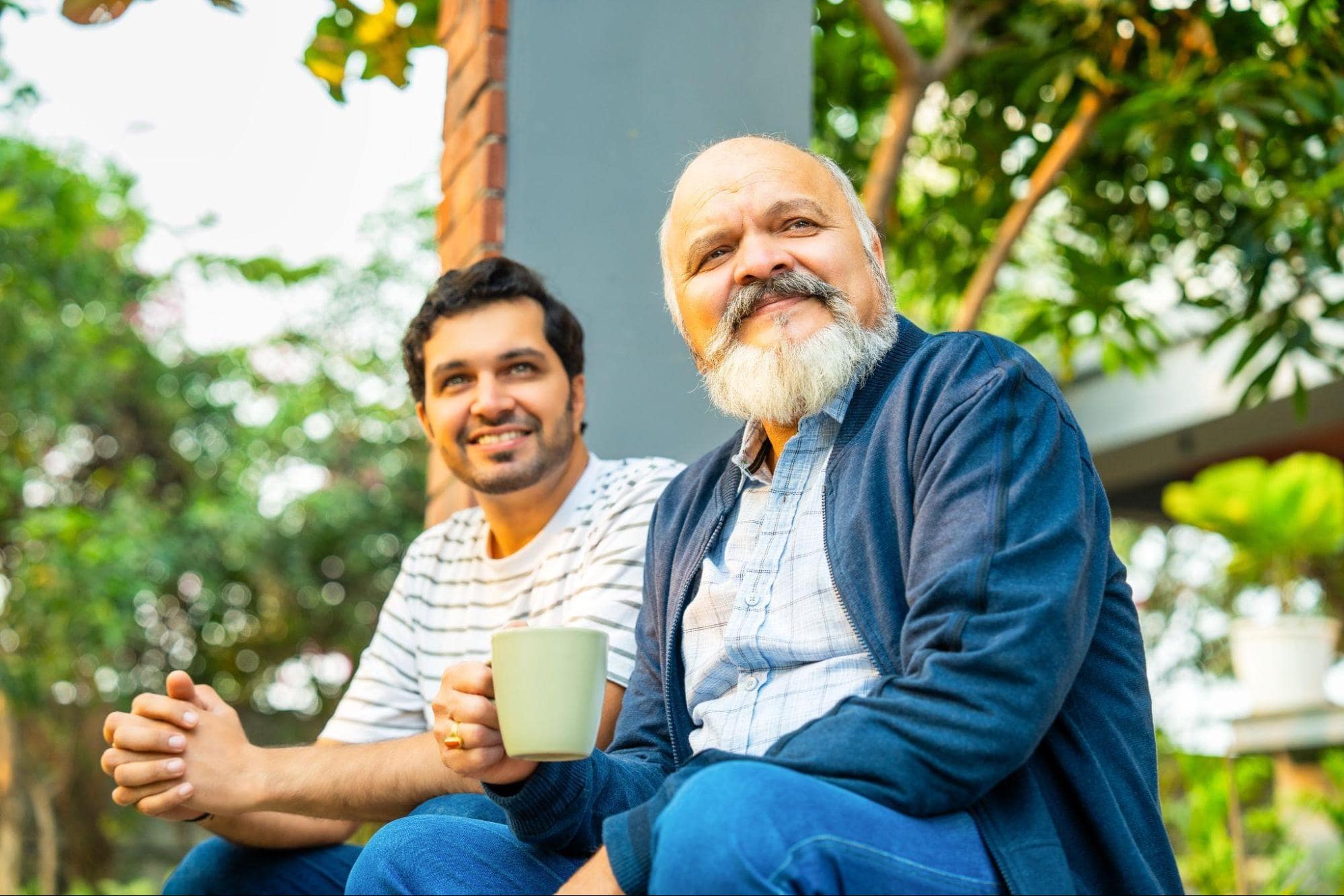 Father and son sitting on porch