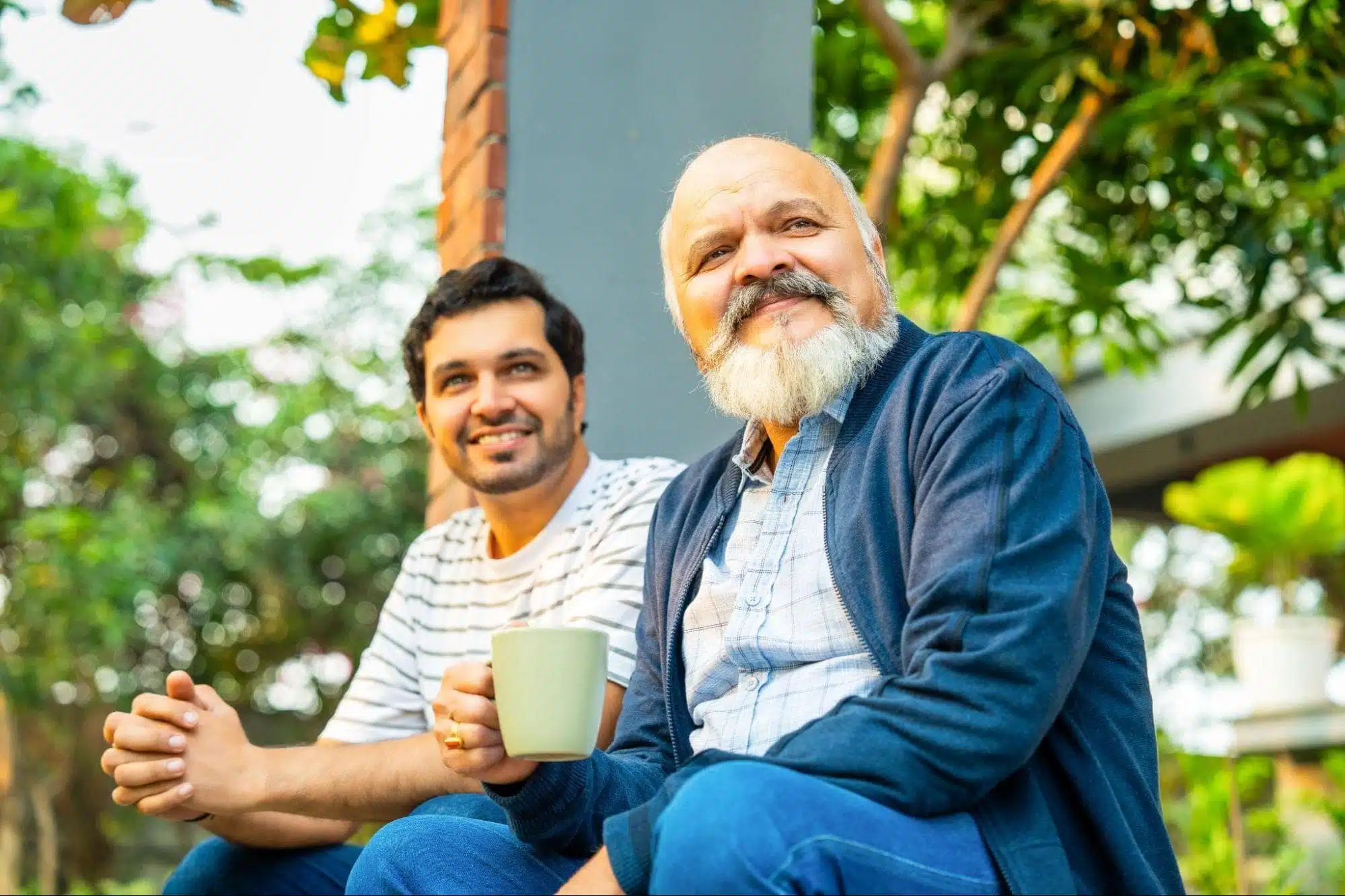 Father and son sitting on porch