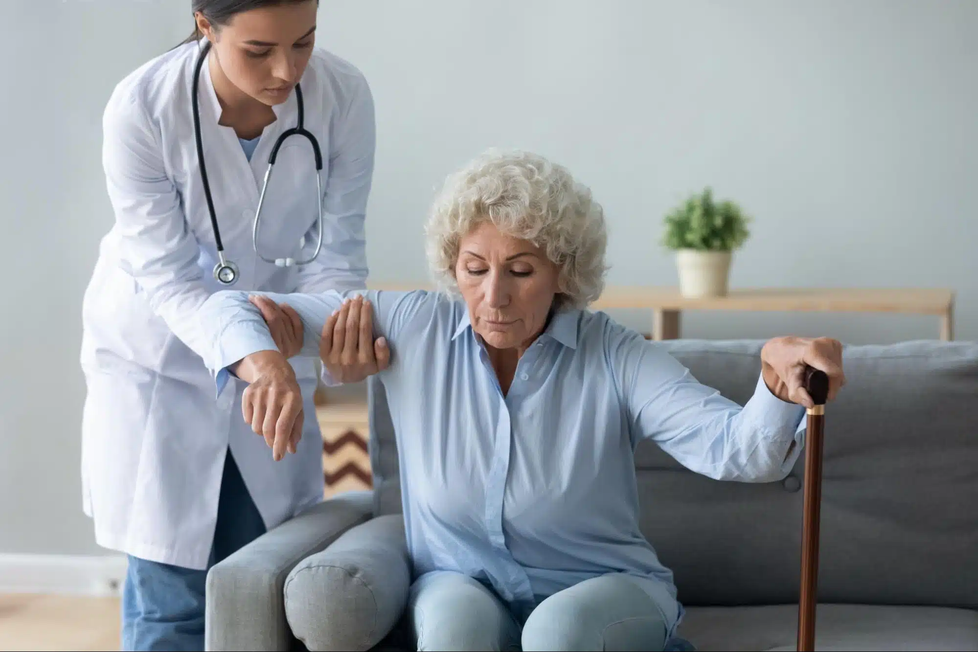 Doctor helping patient stand up