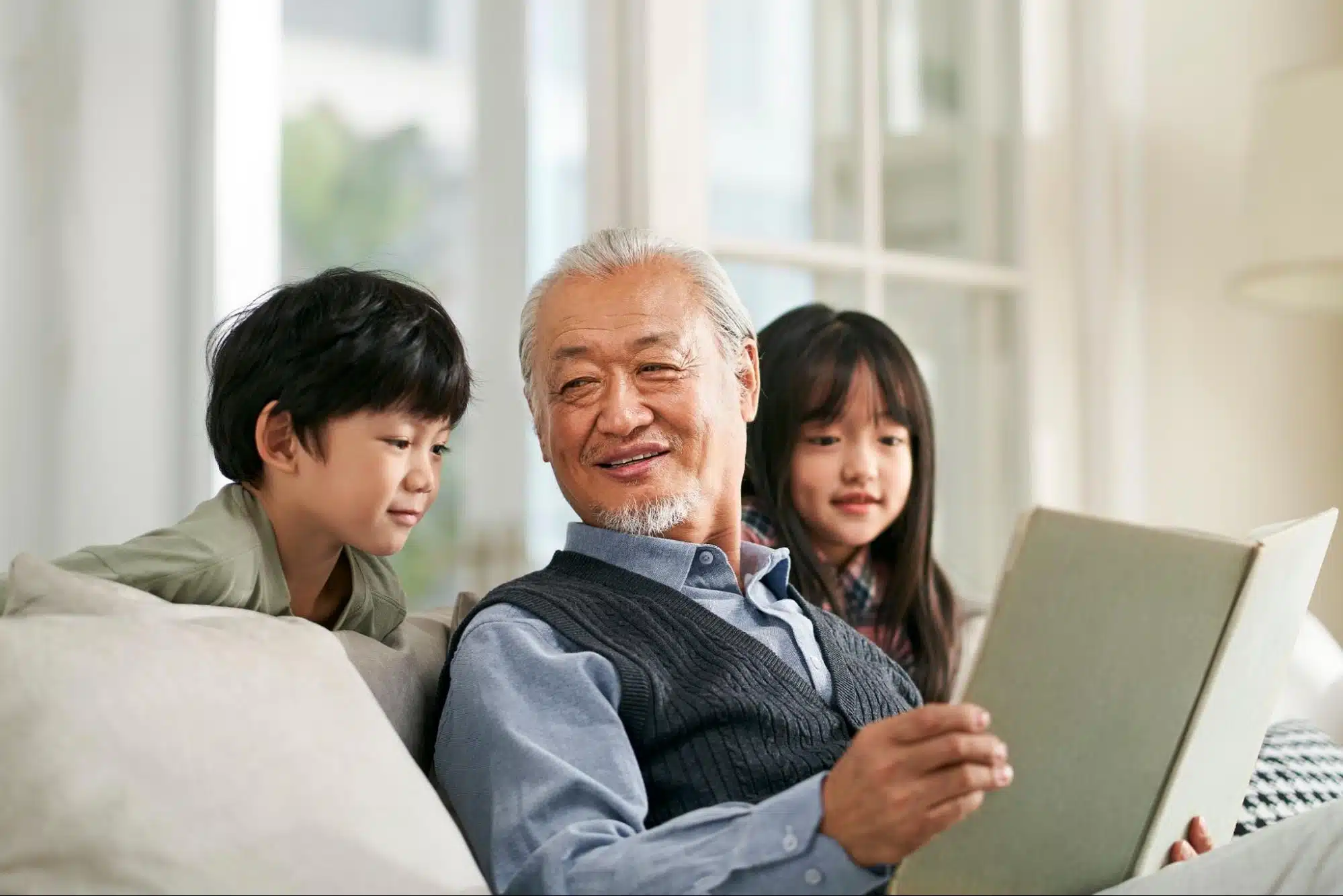 Grandpa reading a book to his grandkids