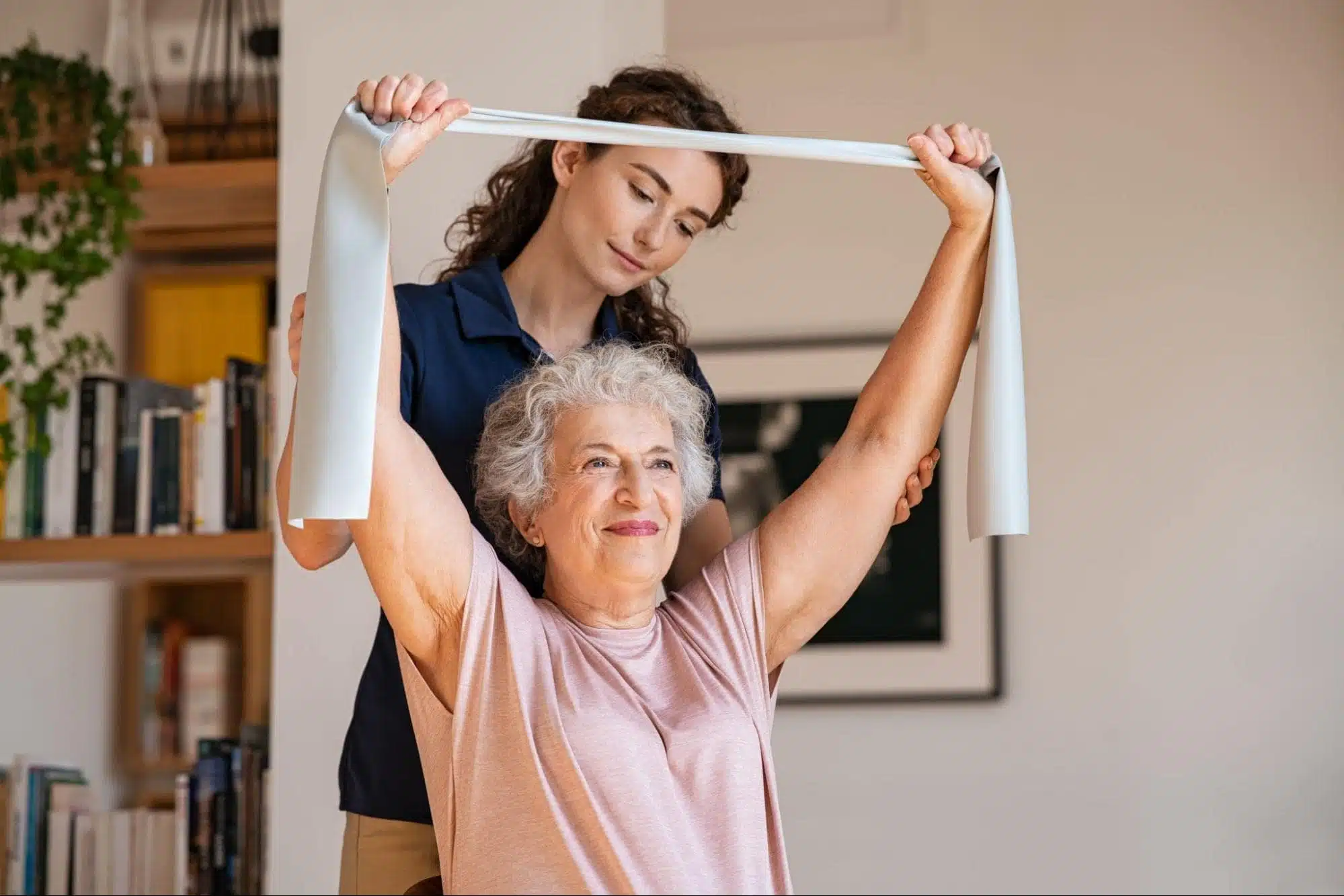 Caregiver helping a senior do exercises