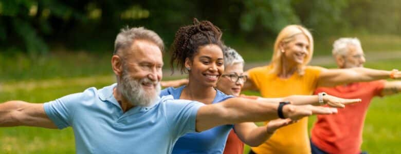 A group of people doing yoga outside