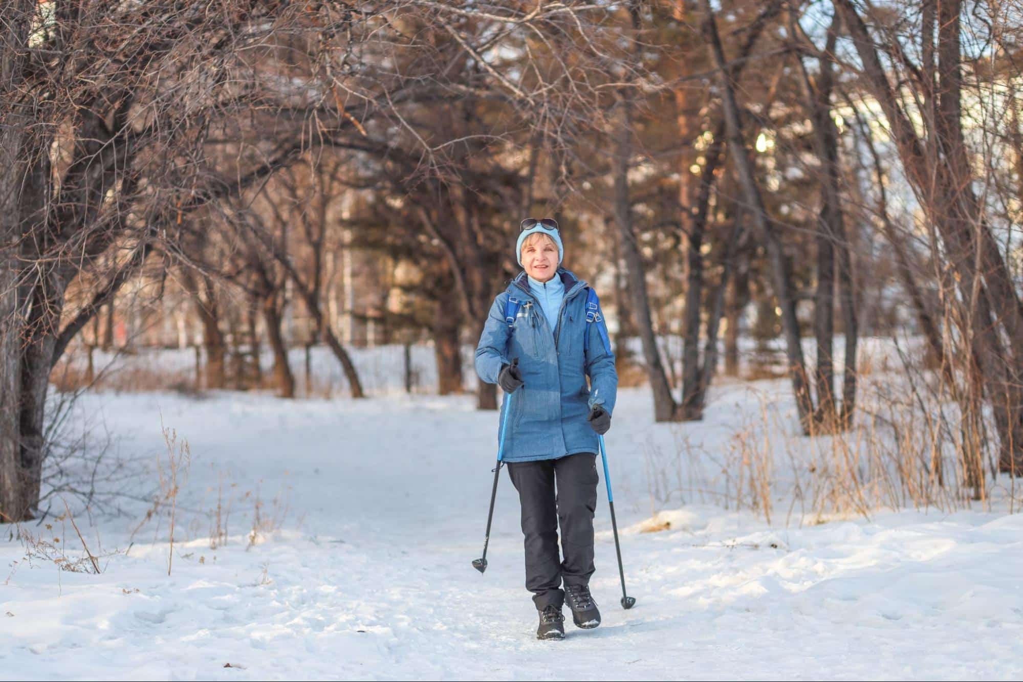Senior walking outside with walking sticks