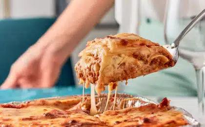 Baked lasagna being pulled out of a pan with a spatula