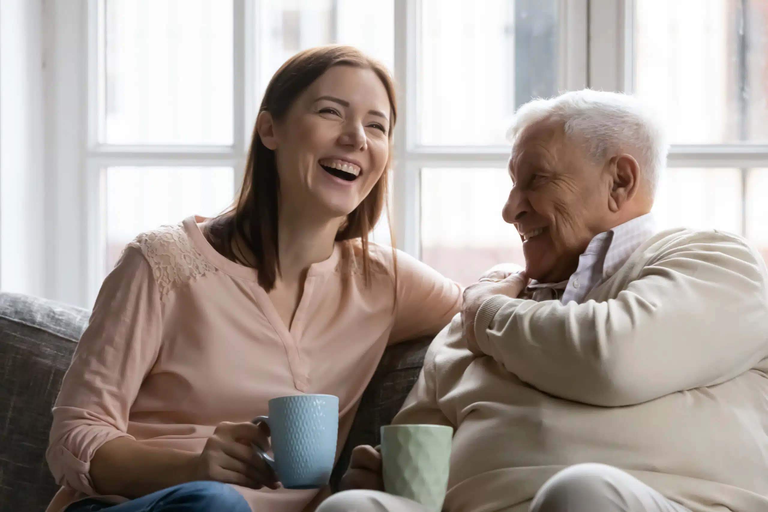 Two people discussing life-saving devices for the elderly.