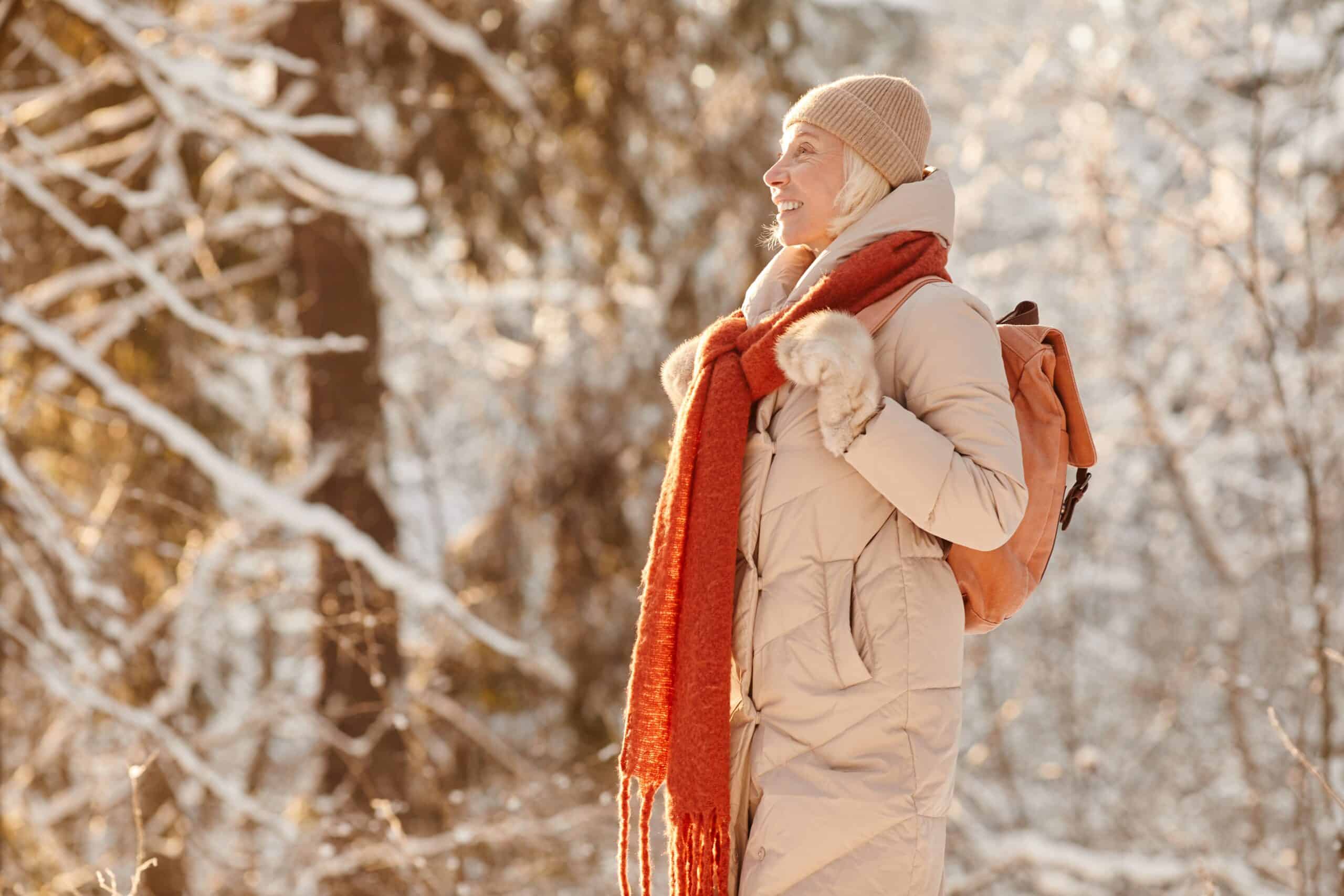 Older woman outside in the proper winter gear for seniors