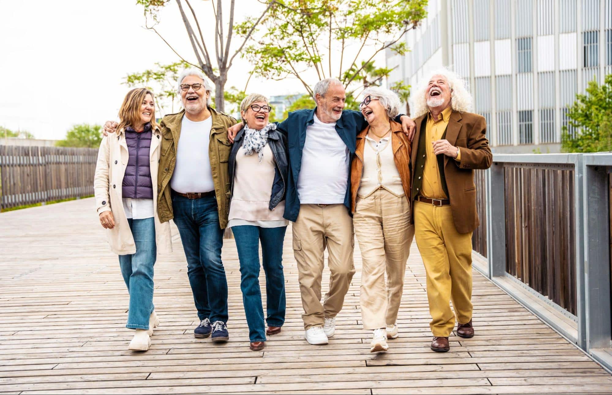 Seniors outside smiling and walking together